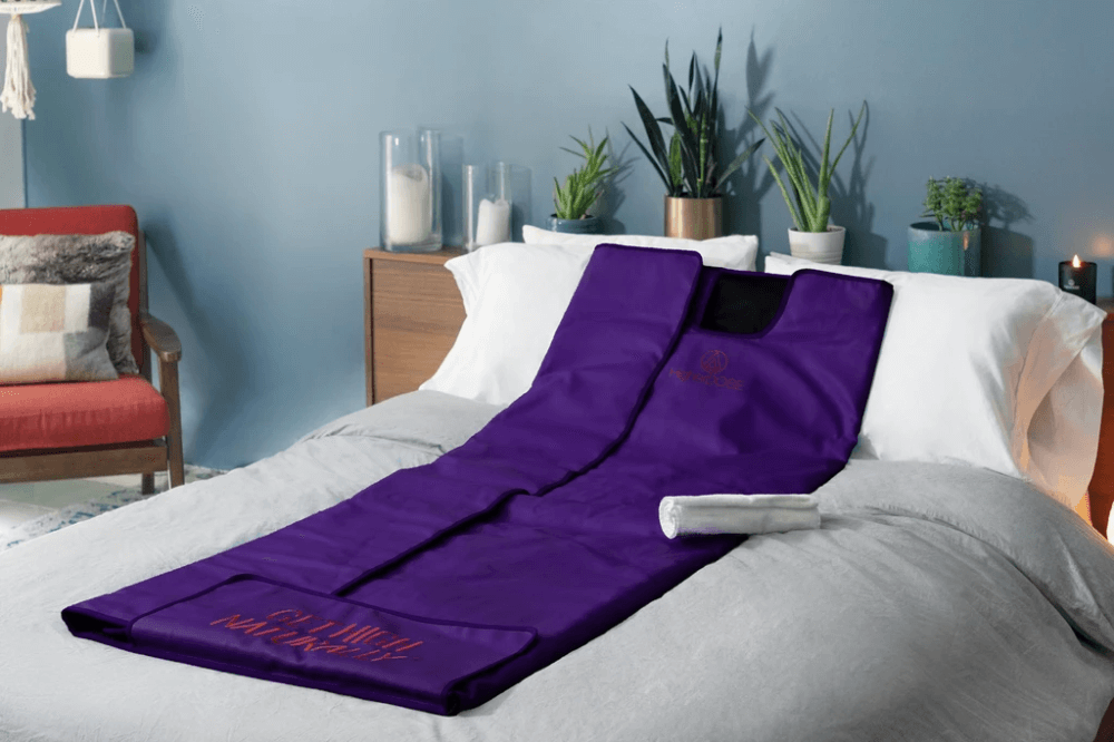 Detox sauna blanket laid out on mattress with clean linen